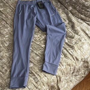 Men’s Nike dri fit blue tapered mens joggers. Medium never worn